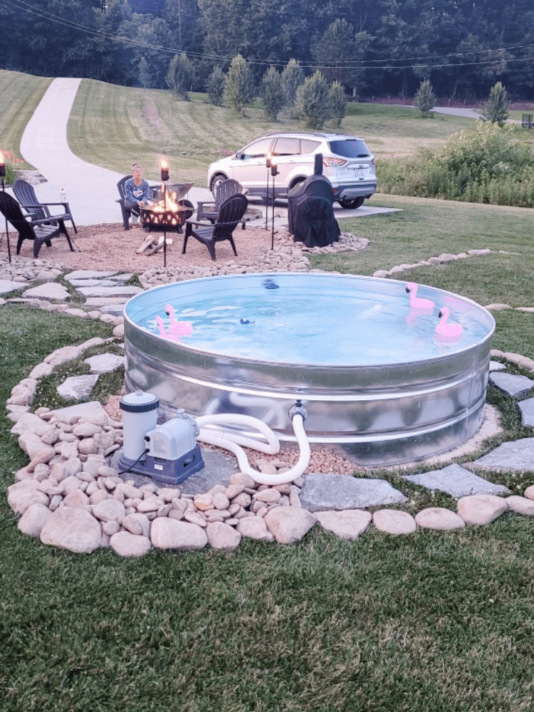 Outlining the stock tank pool with river rock