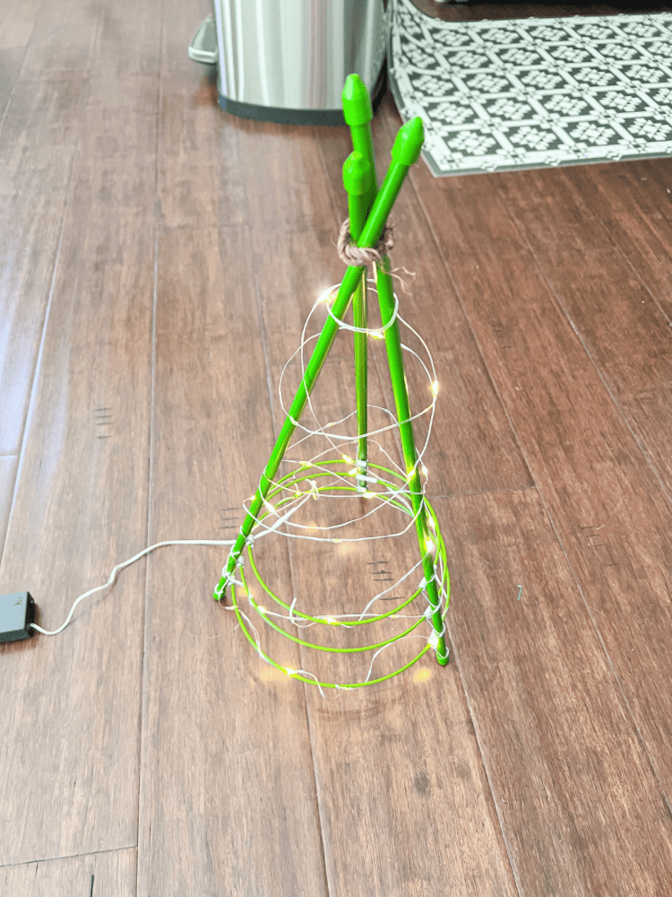 Wrapping String Lights Around the Base of The Tomato Cage